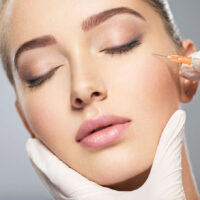 a woman receiving Botox treatment on her face