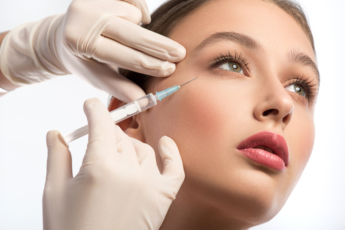 A woman undergoing botox treatment, injectables are being used